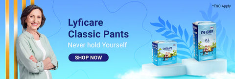 A bright blue banner featuring a smiling woman with folded arms next to two sizes (L and XL) of Lyfcare Classic Pants. The slogan says "Never hold Yourself" with a "Shop Now" button.
